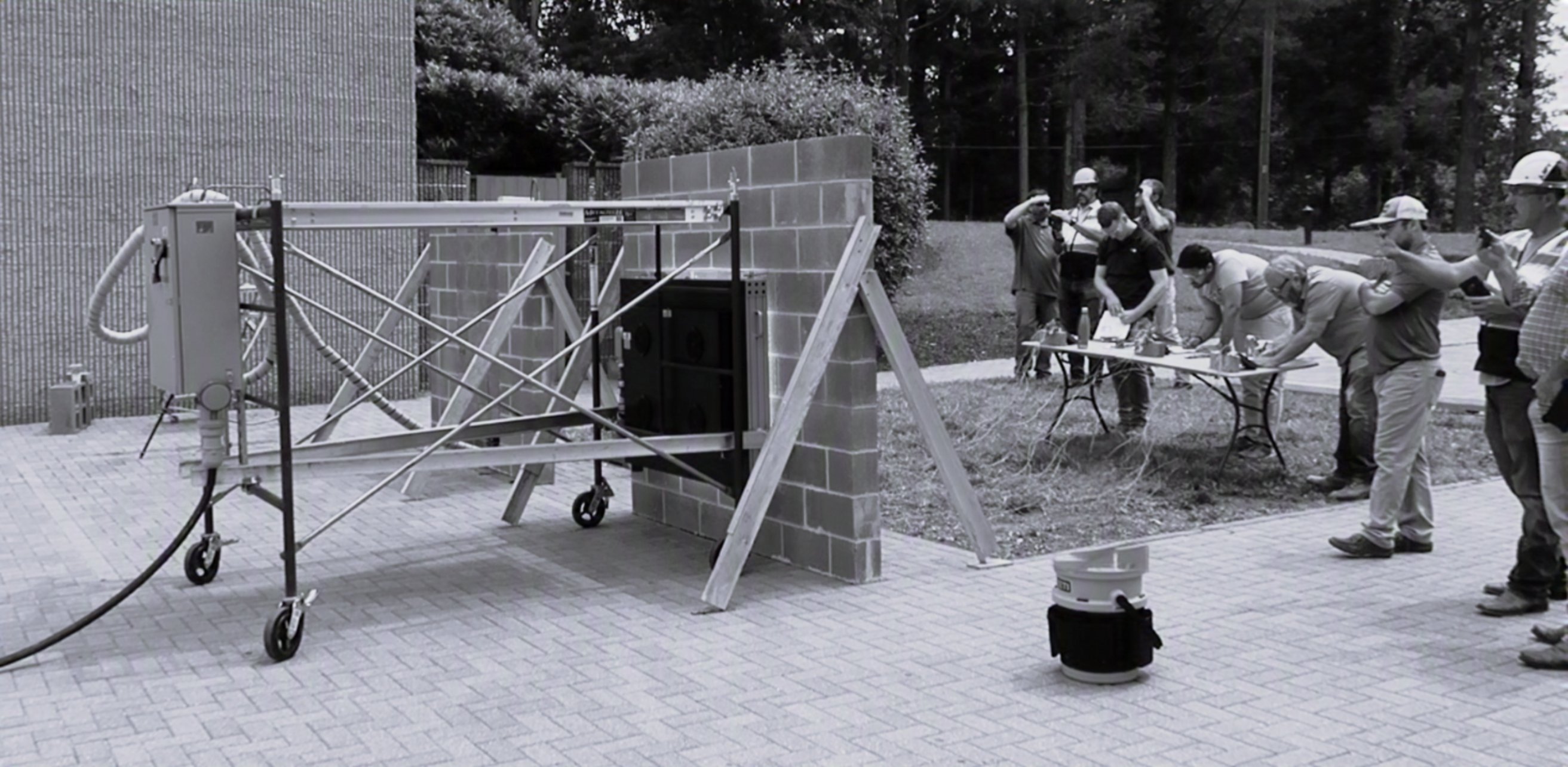 Independent NCMA test of the wall assembly — the radiant unit on its rolling rig, researchers recording data